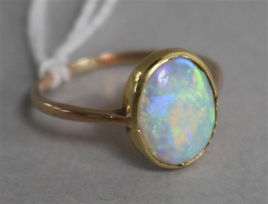 A yellow metal and white opal ring, size M.